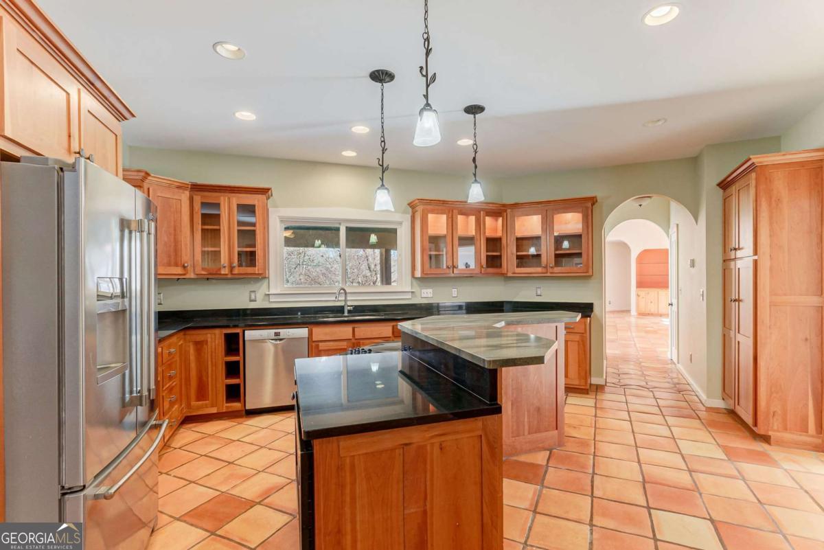 2223 Salem Road Watkinsville, GA 30677 - Photo 33 of 63 a kitchen with stainless steel appliances granite countertop a stove a sink and a refrigerator