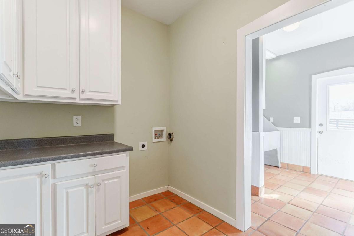 2223 Salem Road Watkinsville, GA 30677 - Photo 38 of 63 a kitchen with granite countertop a sink and a white cabinets
