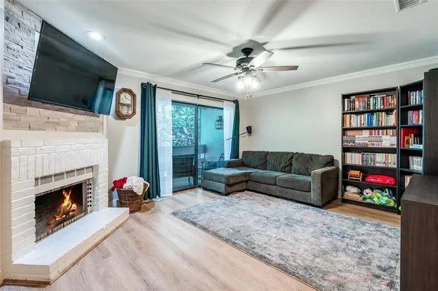 a living room with furniture a flat screen tv and a fireplace