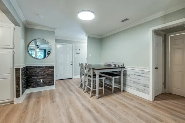 an empty room with wooden floor a fireplace and a window
