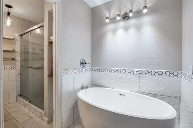 a bathroom with a bathtub and shower