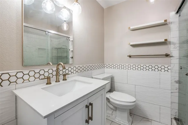 a bathroom with a sink toilet and vanity