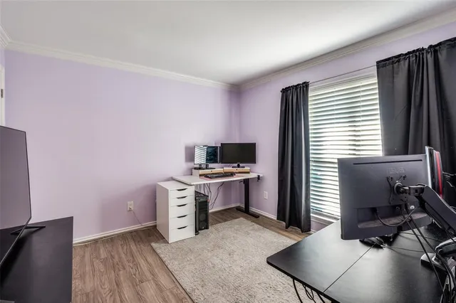 a kitchen with a stove and a wooden floor