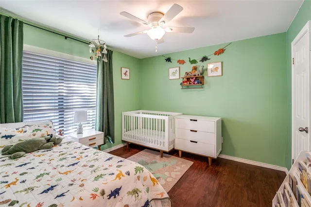 a bedroom with a baby bed and a window