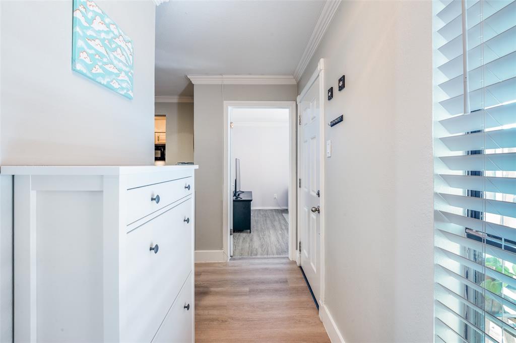 5840 Spring Valley Road, Unit 802 Dallas, TX 75254 - Photo 20 of 26 a view of a hallway with closet and wooden floor
