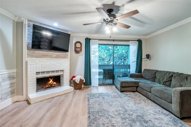 a living room with furniture fireplace and flat screen tv