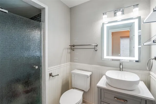 a bathroom with a toilet sink and shower