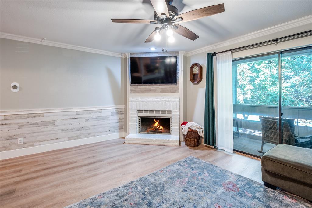 5840 Spring Valley Road, Unit 802 Dallas, TX 75254 - Photo 3 of 26 a living room with furniture and a fireplace