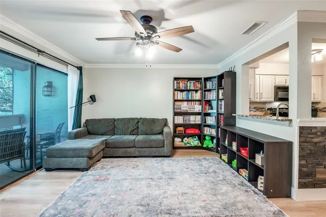 a living room with furniture and a book shelf