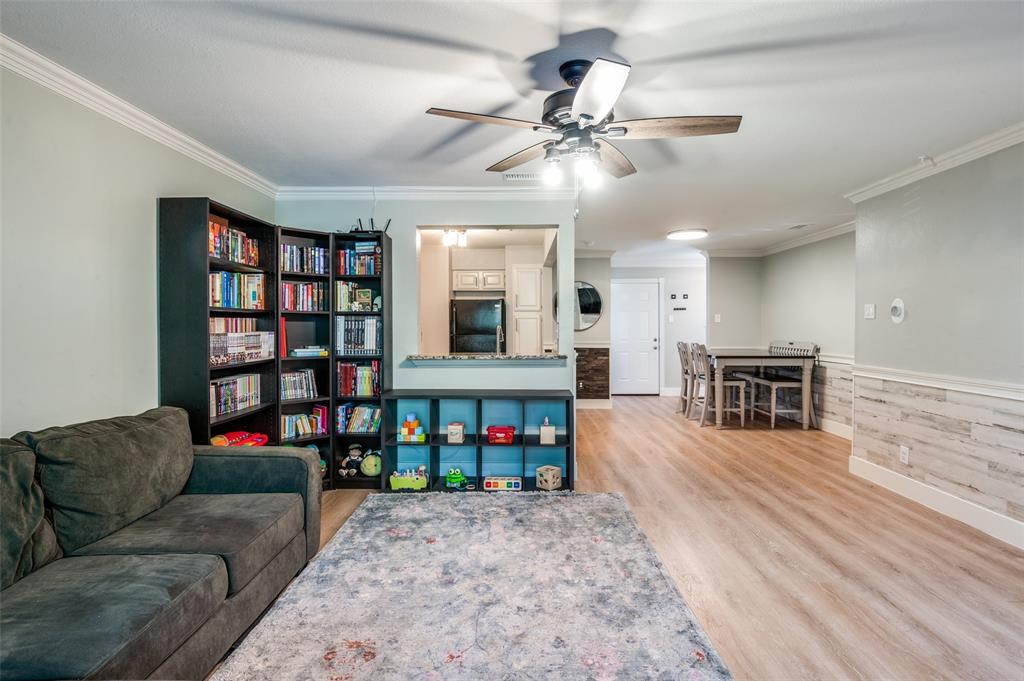 5840 Spring Valley Road, Unit 802 Dallas, TX 75254 - Photo 5 of 26 a living room with fireplace furniture and a wooden floor