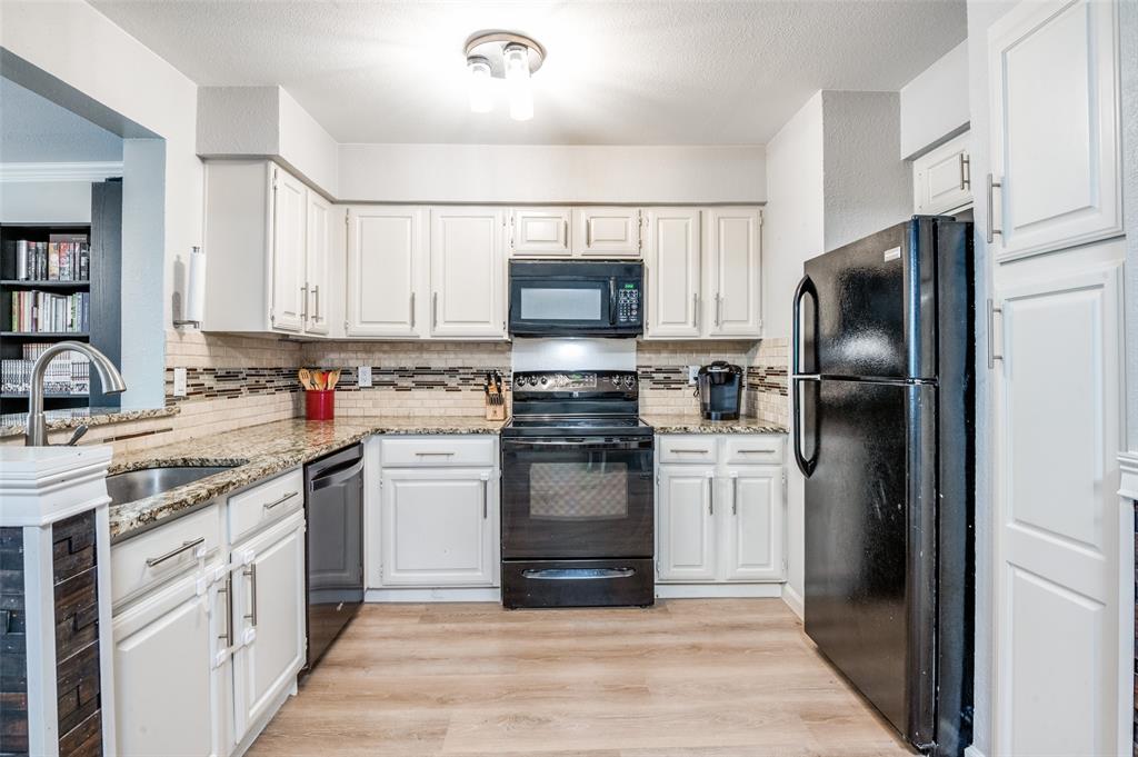 5840 Spring Valley Road, Unit 802 Dallas, TX 75254 - Photo 8 of 26 a kitchen with a refrigerator stove and sink