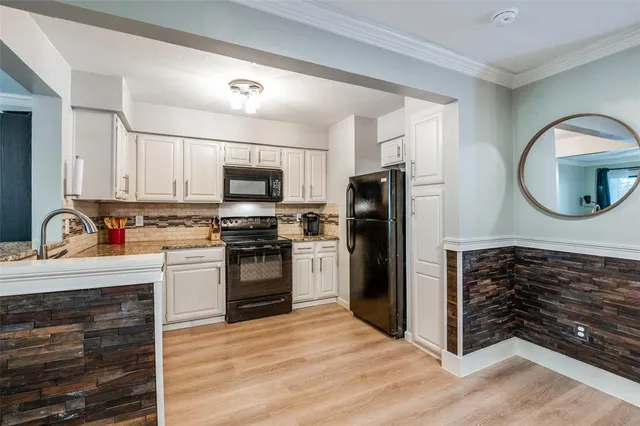 a kitchen with stainless steel appliances granite countertop a refrigerator stove and sink