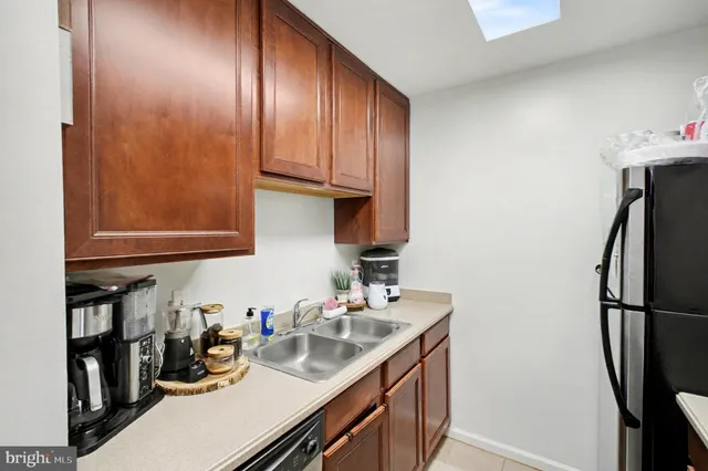 a kitchen with refrigerator and cabinets