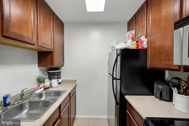 a kitchen with stainless steel appliances granite countertop a sink refrigerator and microwave