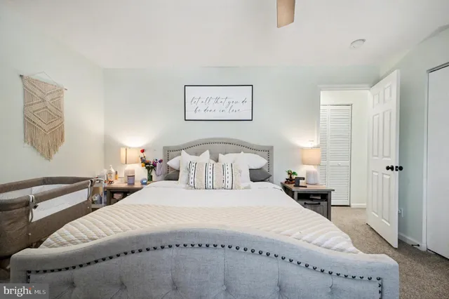 a bedroom with double bed and a lamp