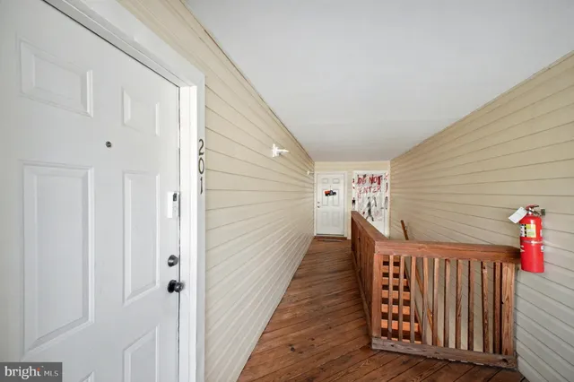 a view of a porch with wooden floor and stairs