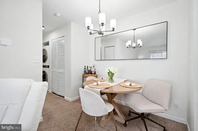 a view of a dining room with furniture wooden floor and a chandelier