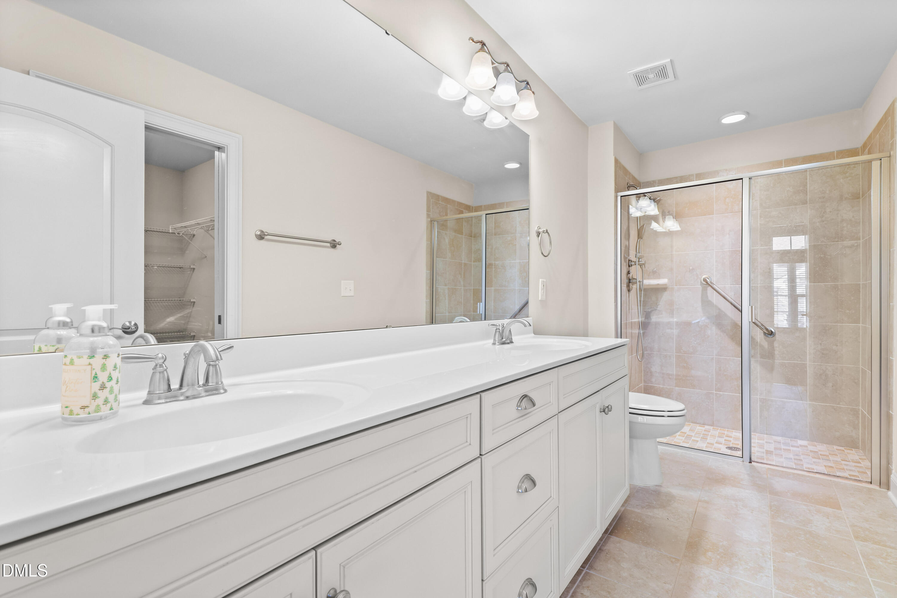 1663 Winter Wren Circle Wake Forest, NC 27587 - Photo 16 of 31 a bathroom with a double vanity sink toilet and shower