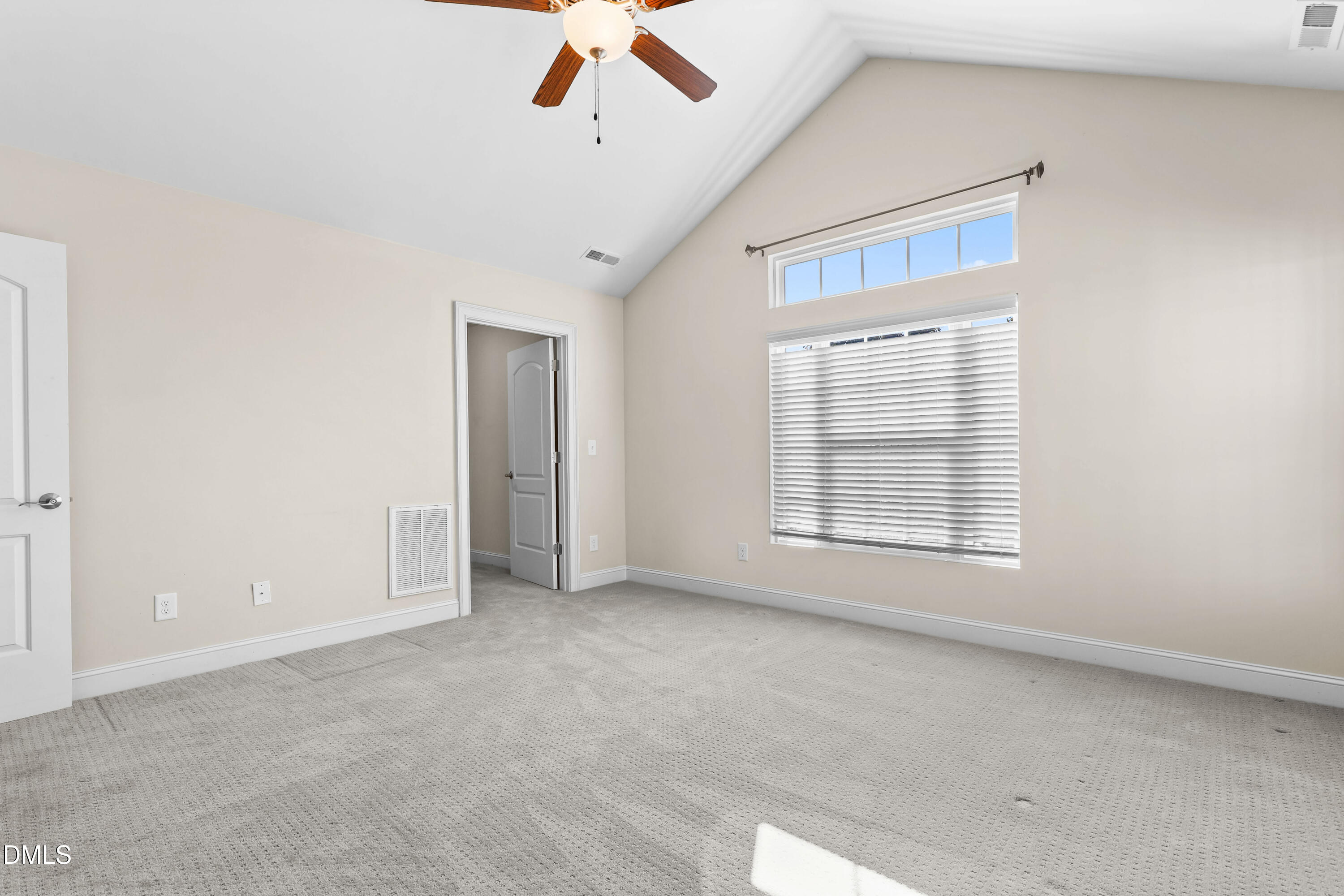 1663 Winter Wren Circle Wake Forest, NC 27587 - Photo 19 of 31 an empty room with chandelier fan and windows
