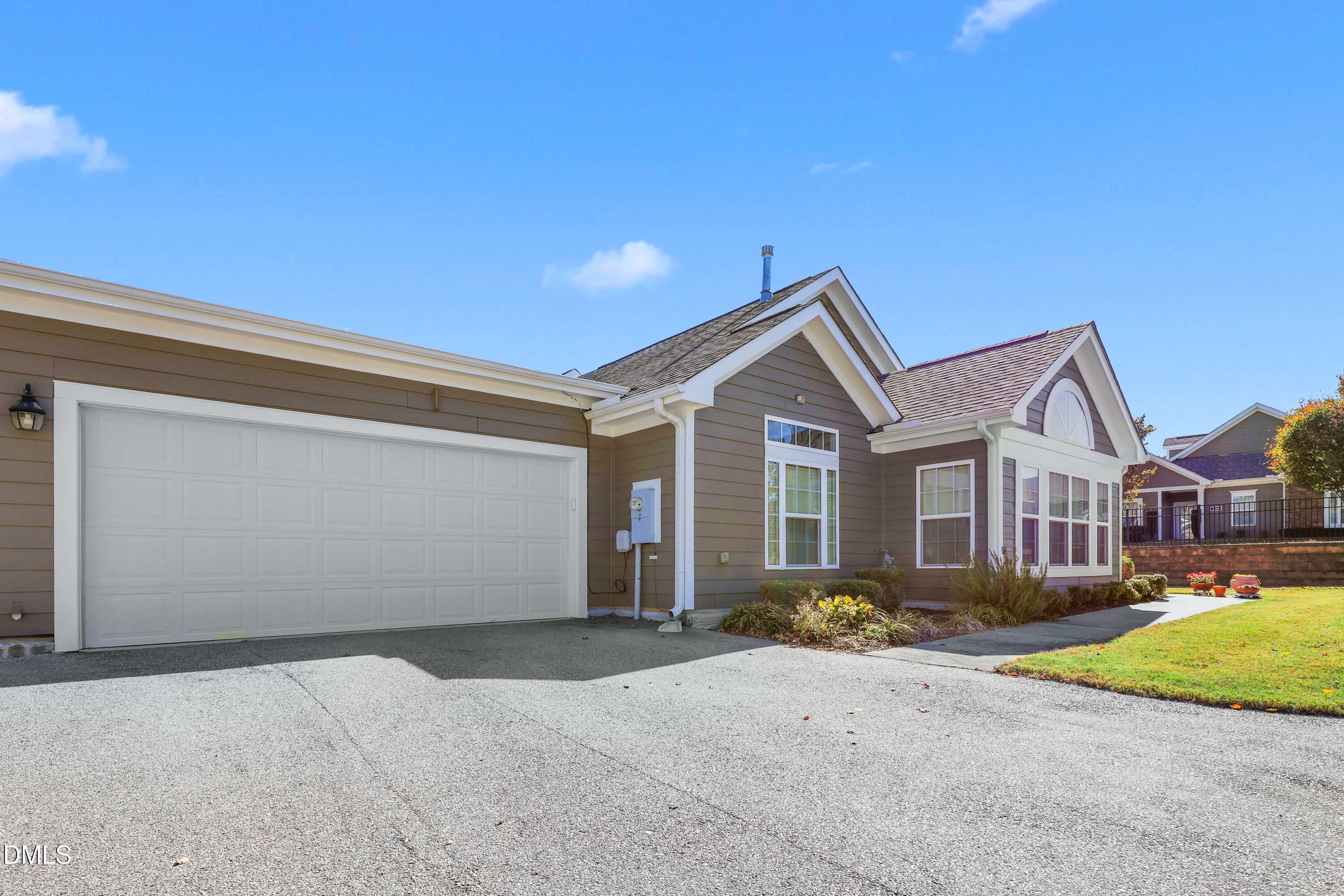 1663 Winter Wren Circle Wake Forest, NC 27587 - Photo 2 of 31 a front view of a house with a yard and garage