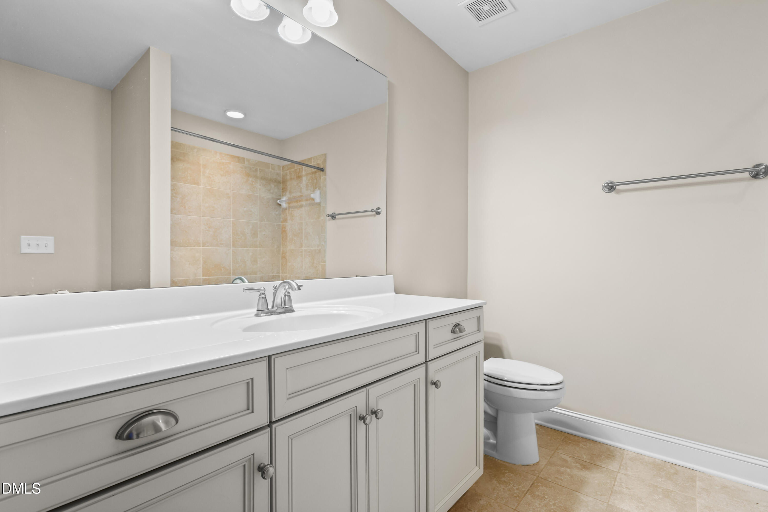 1663 Winter Wren Circle Wake Forest, NC 27587 - Photo 22 of 31 a bathroom with a sink a toilet and vanity