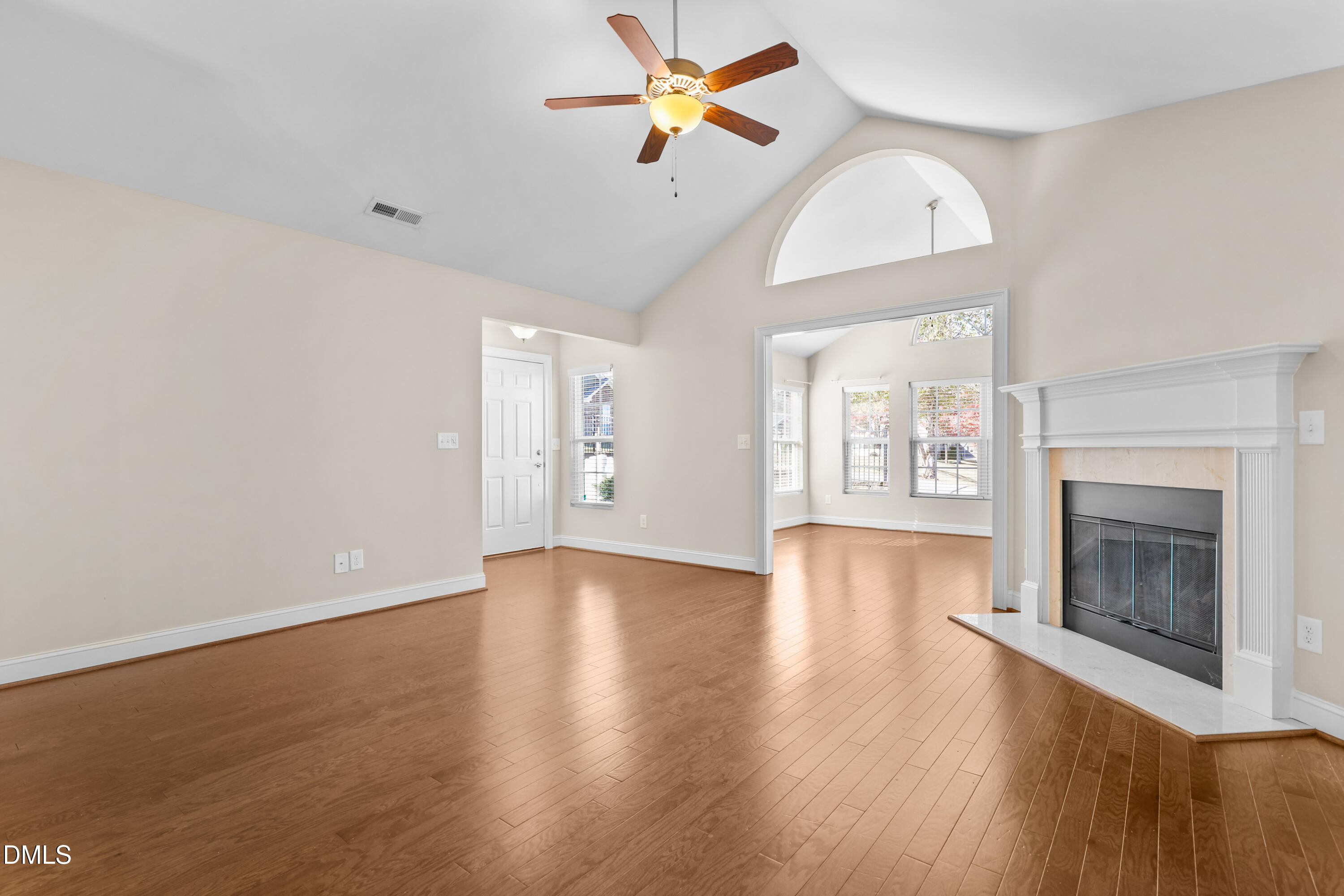 1663 Winter Wren Circle Wake Forest, NC 27587 - Photo 5 of 31 an empty room with wooden floor fan and windows