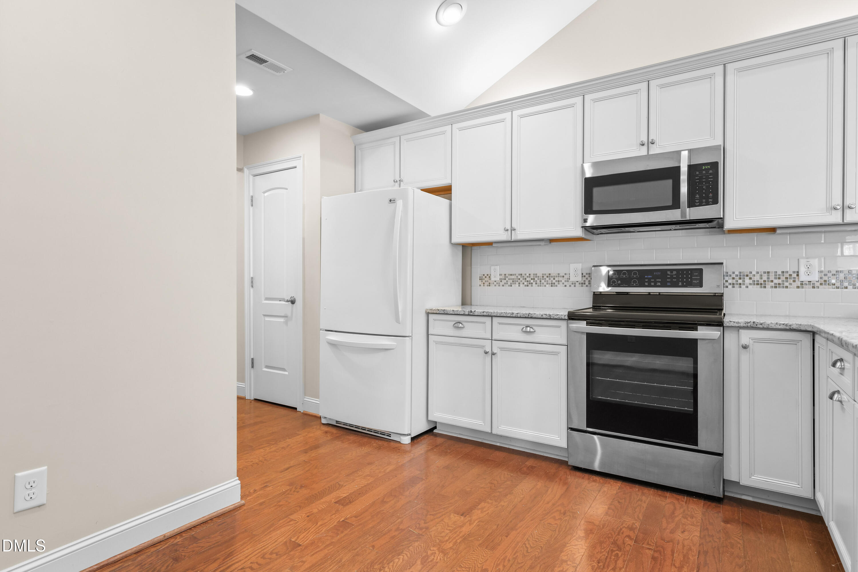 1663 Winter Wren Circle Wake Forest, NC 27587 - Photo 10 of 31 a kitchen with stainless steel appliances a stove and a microwave