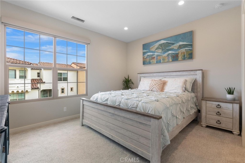 125 Leafy Twig Irvine, CA 92618 - Photo 17 of 35 a bedroom with a large bed and a window
