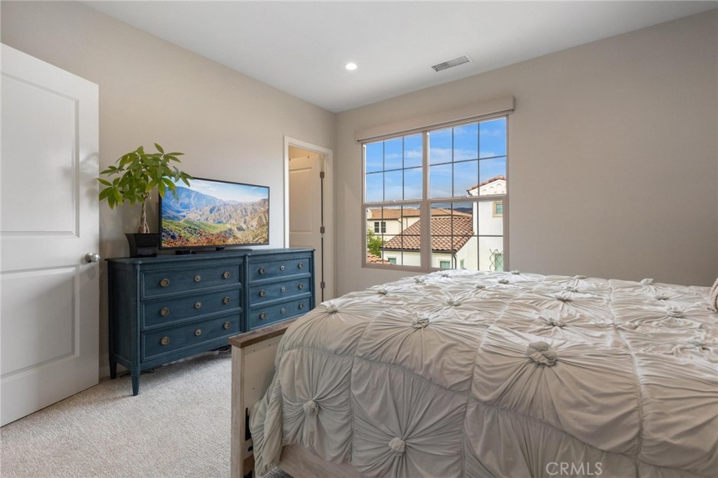 125 Leafy Twig Irvine, CA 92618 - Photo 18 of 35 a bedroom with a bed and a dresser