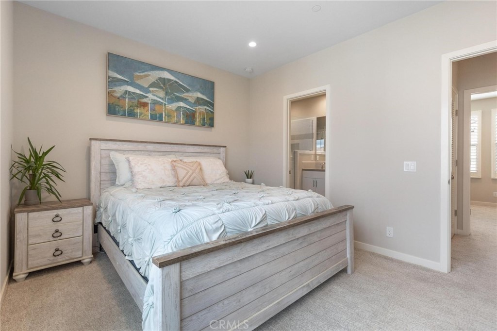 125 Leafy Twig Irvine, CA 92618 - Photo 19 of 35 a bedroom with a bed and a painting on the wall