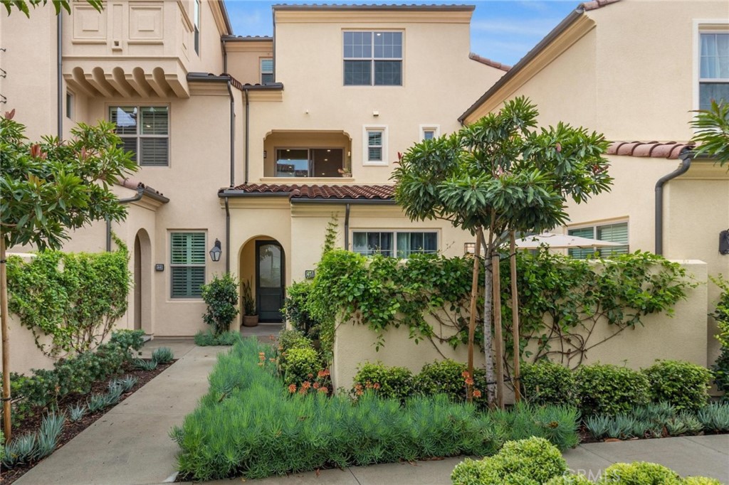 125 Leafy Twig Irvine, CA 92618 - Photo 2 of 35 a front view of a house with a garden