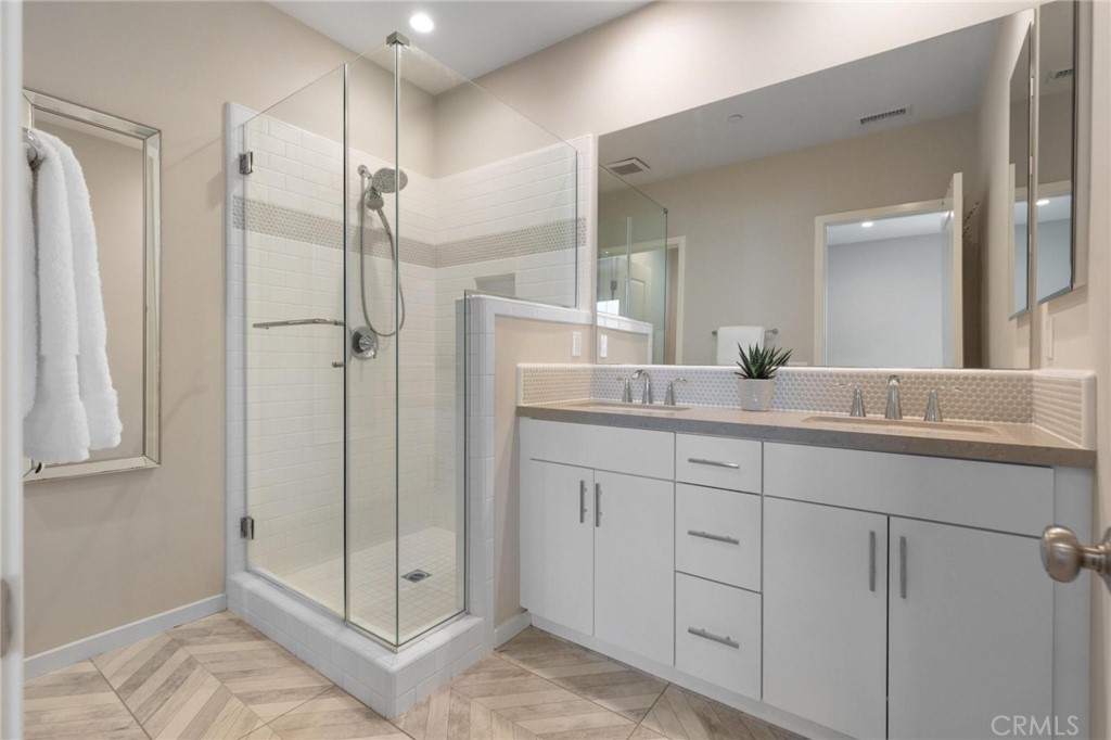 125 Leafy Twig Irvine, CA 92618 - Photo 21 of 35 a bathroom with a shower sink and mirror