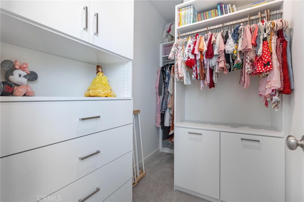 125 Leafy Twig Irvine, CA 92618 - Photo 25 of 35 a view of walk in closet with clothes and shoes