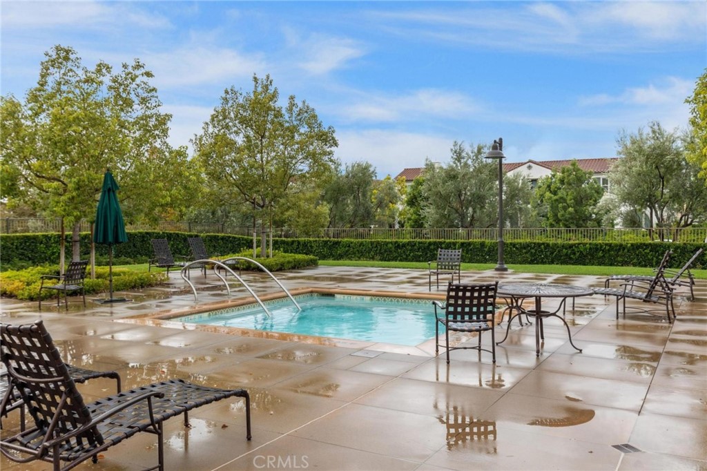 125 Leafy Twig Irvine, CA 92618 - Photo 33 of 35 a view of a swimming pool with chairs in patio