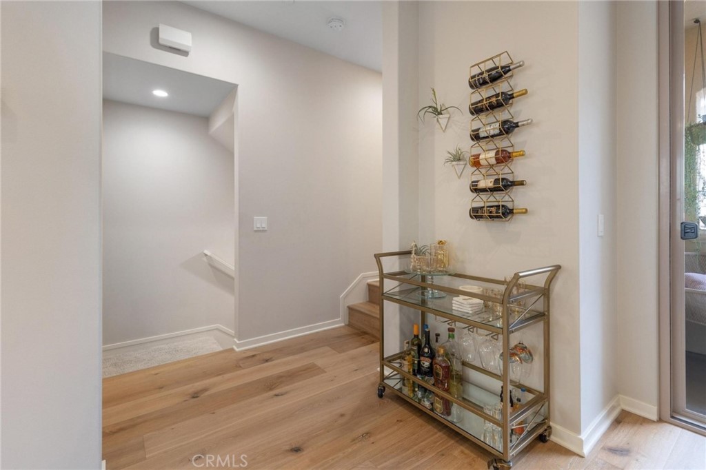 125 Leafy Twig Irvine, CA 92618 - Photo 7 of 35 an empty room with wooden floor mirror and windows