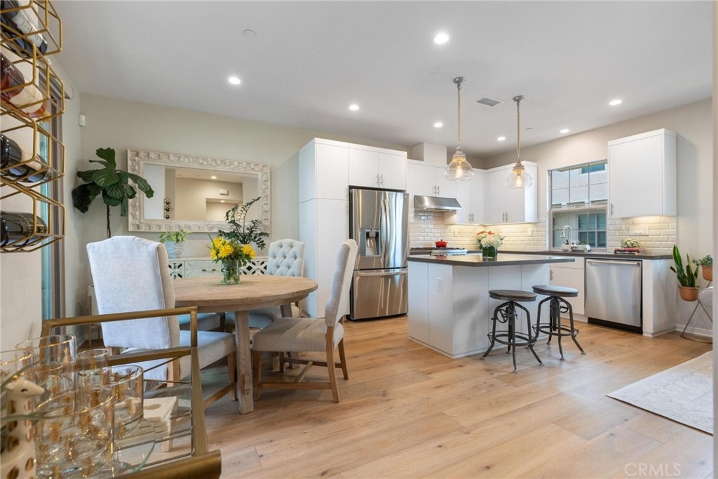 125 Leafy Twig Irvine, CA 92618 - Photo 9 of 35 a kitchen with a dining table chairs and refrigerator
