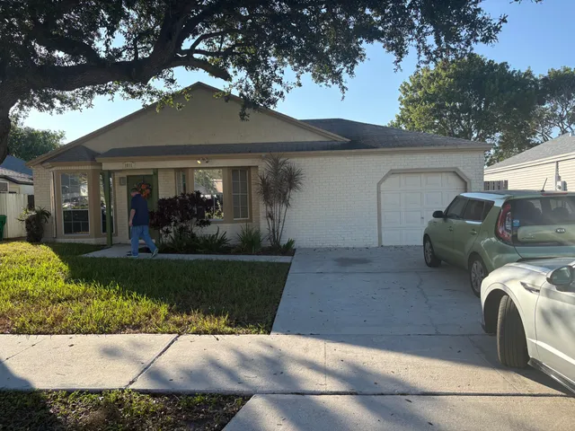 a view of a house with a couches and a large tree