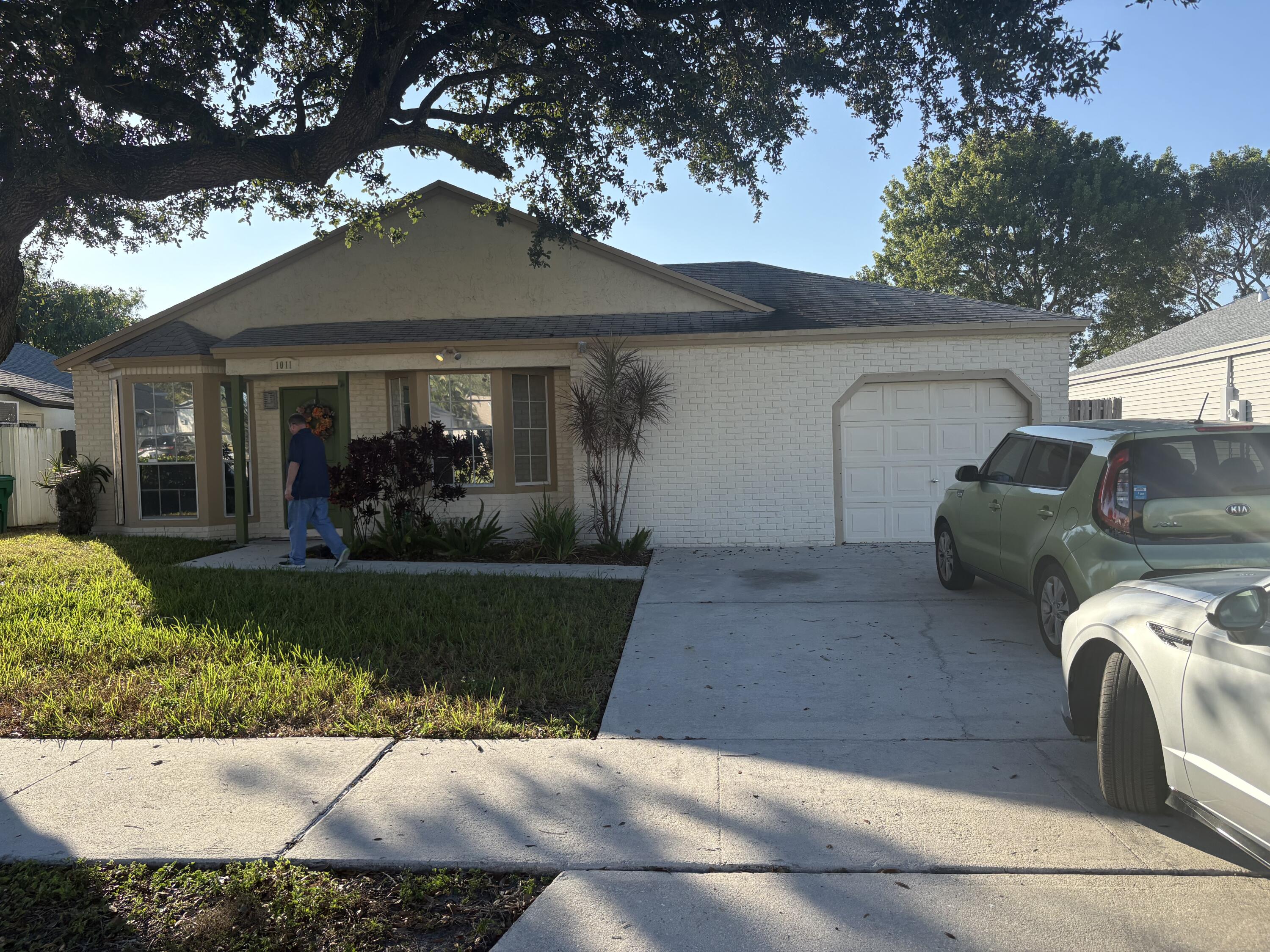 a view of a house with a couches and a large tree