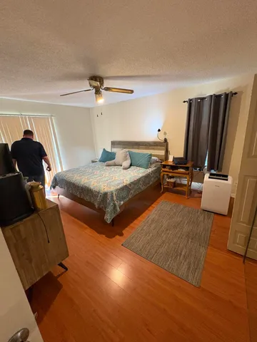 a bedroom with two beds and a couch