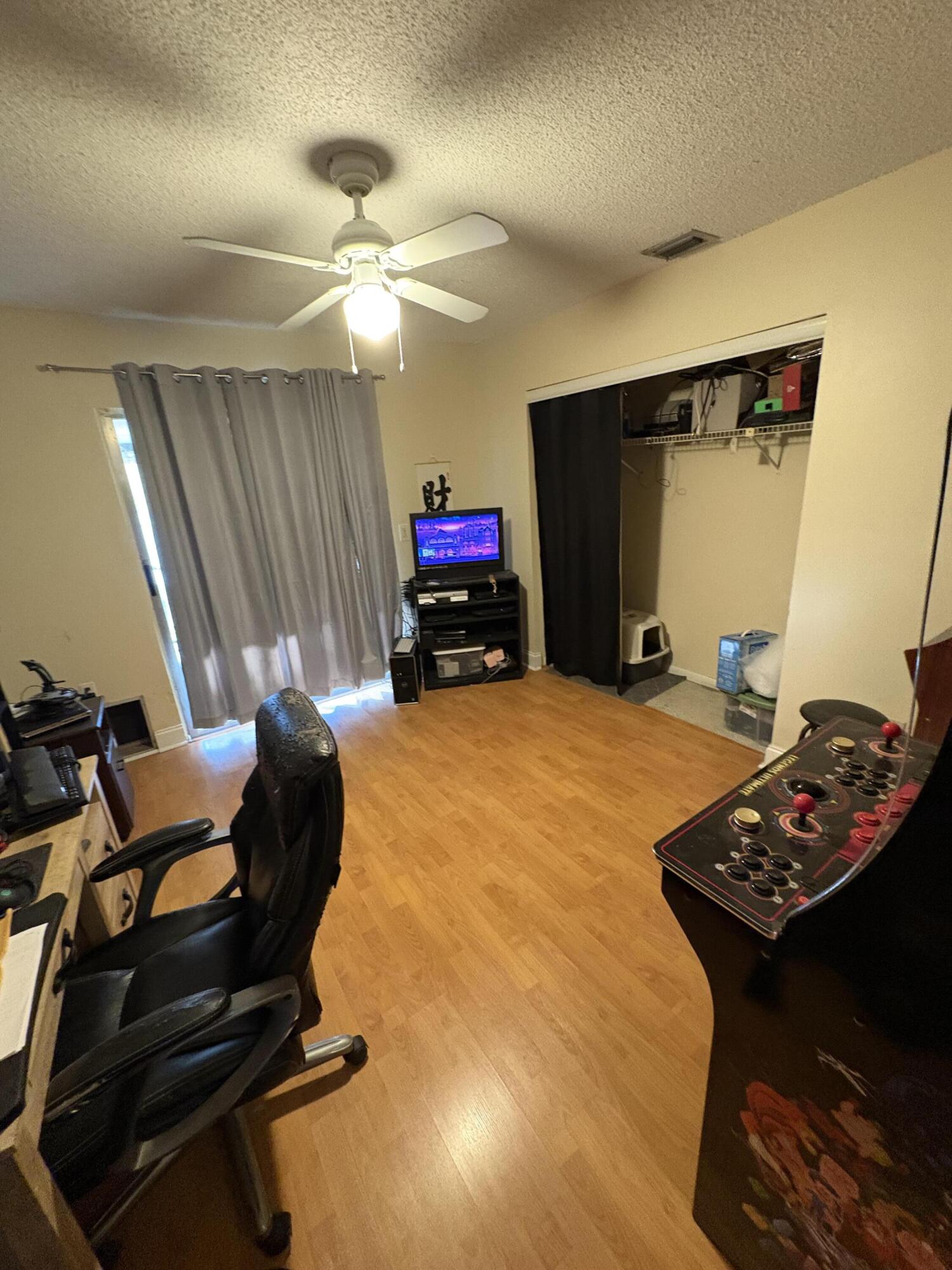 1011 Southwest 134th Avenue Davie, FL 33325 - Photo 14 of 18 a bed room with a bed and a chandelier