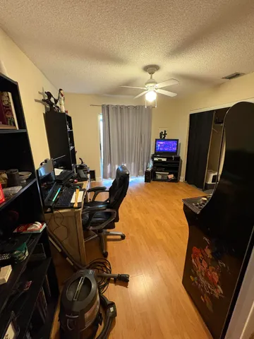 a room with gym equipment and a flat screen tv