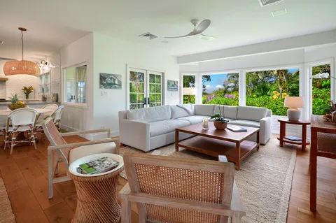 a living room with patio a couch and a large window