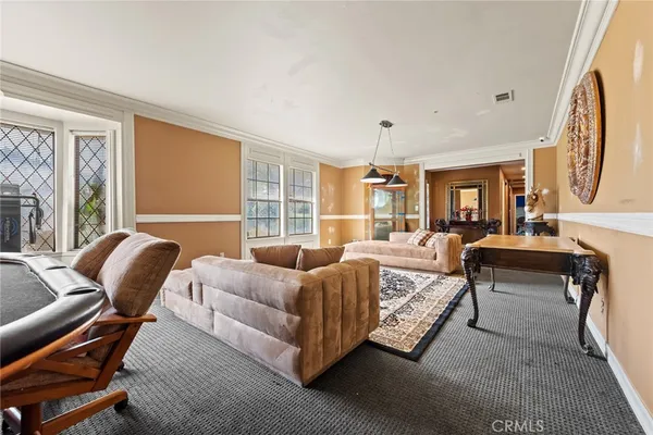 a bedroom with furniture and a large window