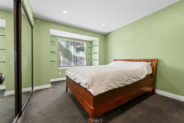 a bed sitting in a room next to a window