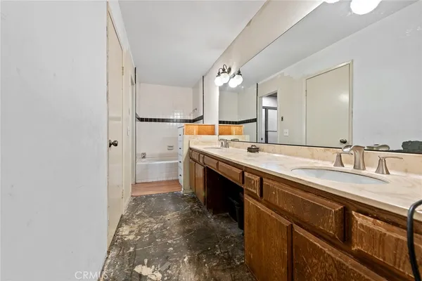 a spacious bathroom with a sink double vanity and a mirror