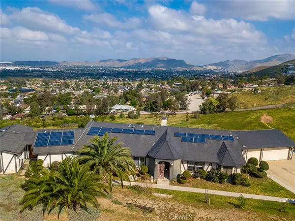 an aerial view of residential houses with outdoor space and ocean view
