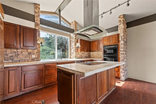 a kitchen with a stove a sink and a refrigerator