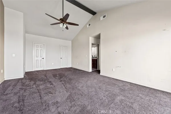 a view of a livingroom with a ceiling fan & window