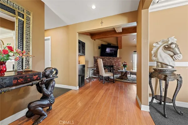 a view of a entryway with dining room and wooden floor