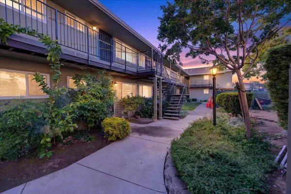 a pathway of a house with a yard